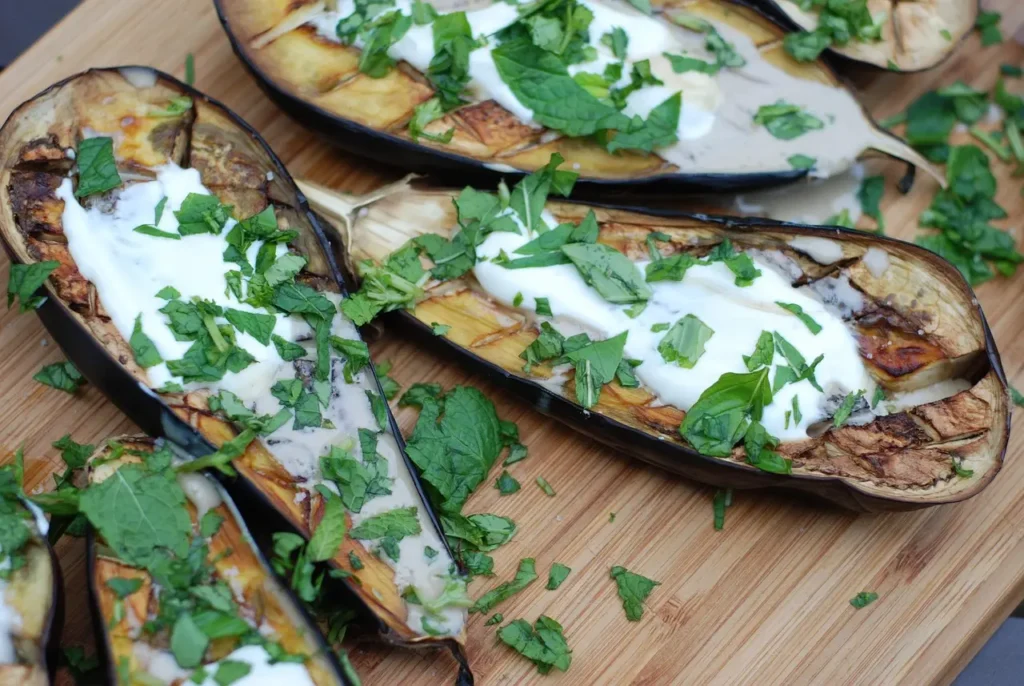 Discover the delightful recipe for baked eggplant rounds topped with gooey mozzarella. This versatile dish can be served as a delectable 